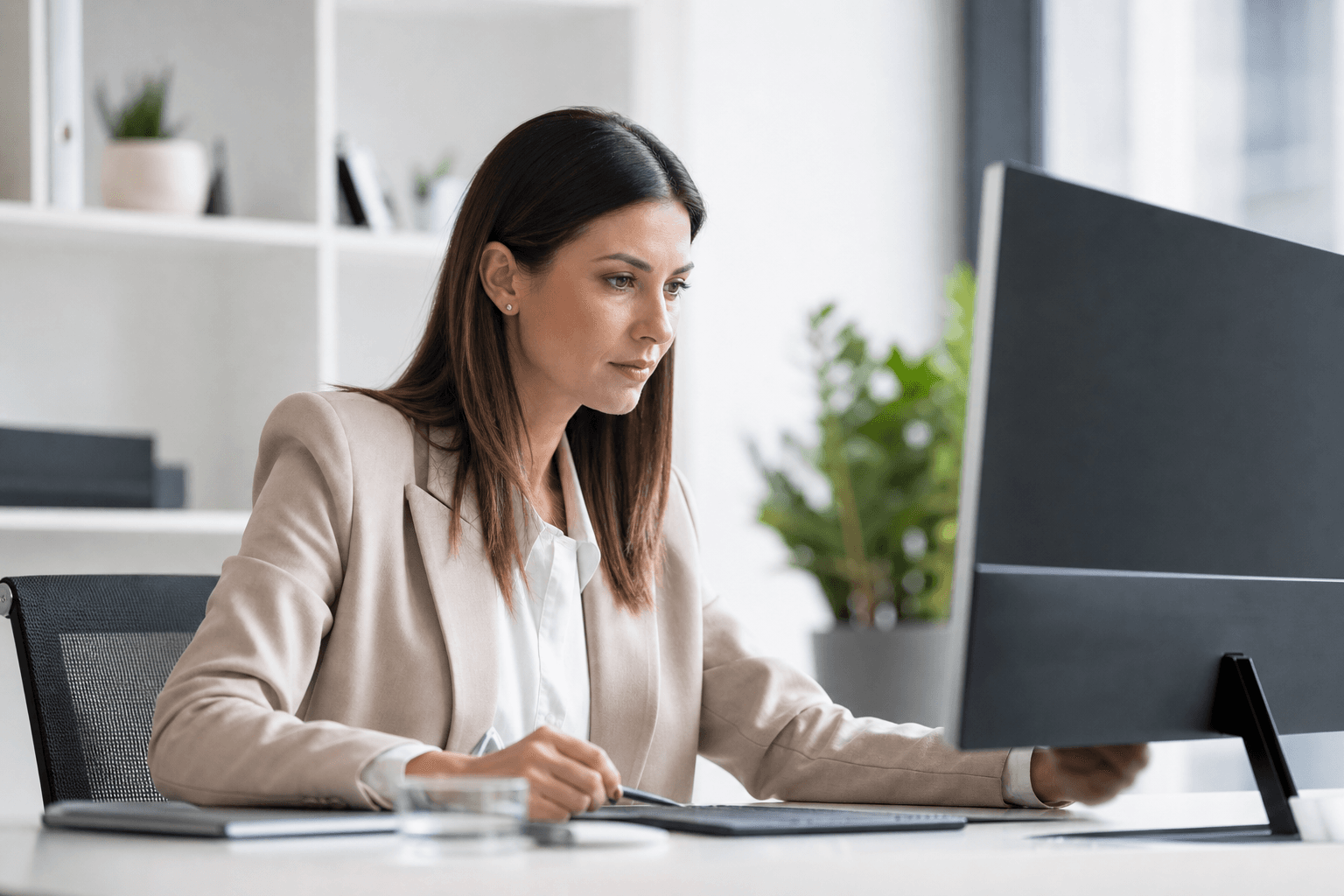 Professional reviewing an approval packet on a desktop screen